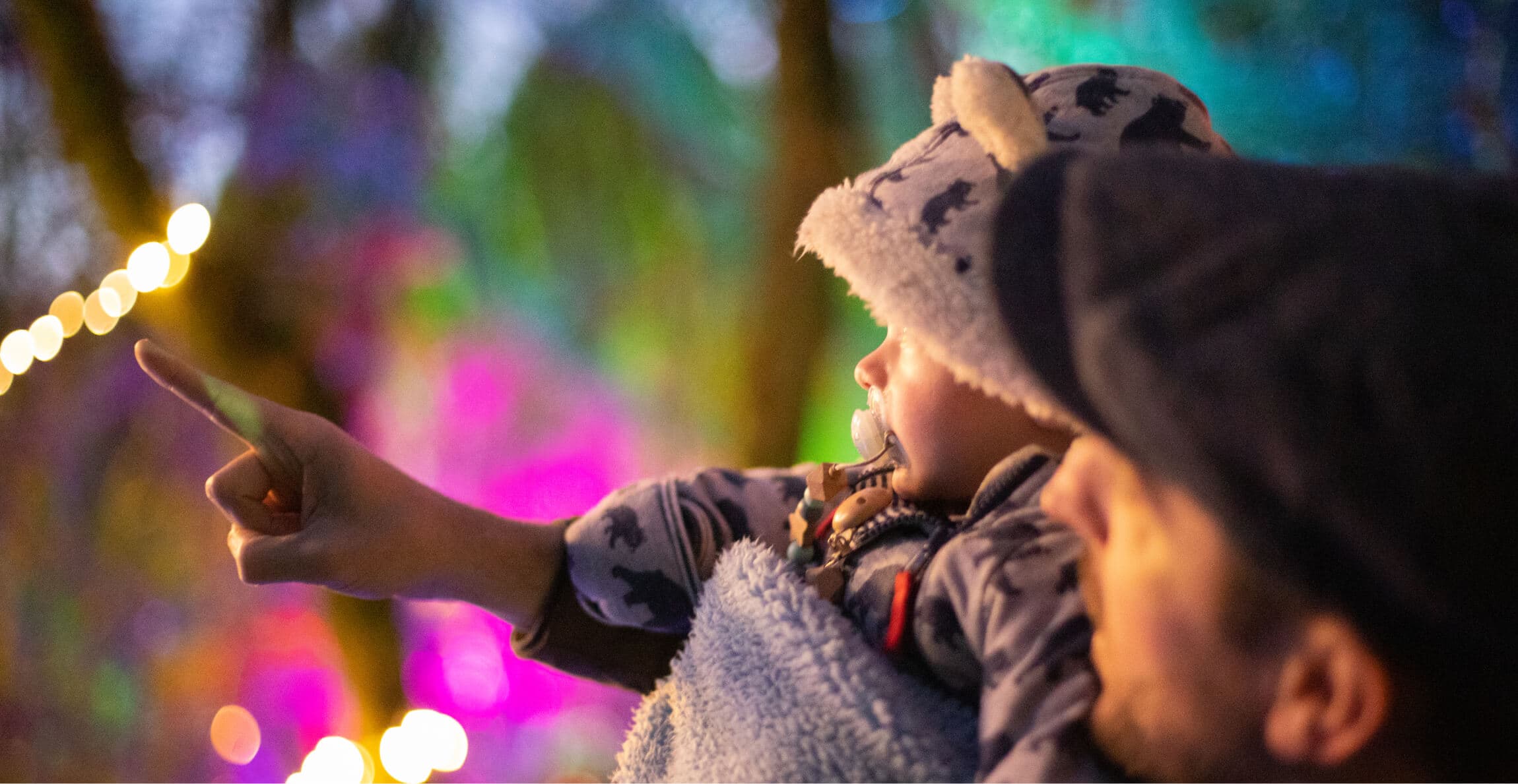 Father and child enjoying colorful lights 