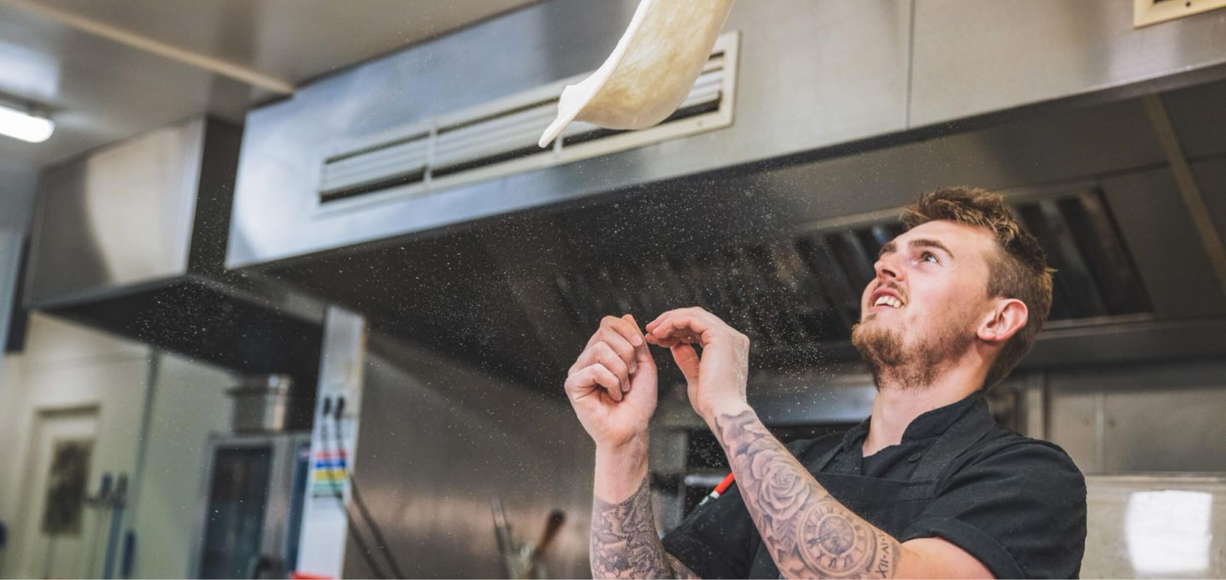 Pizza chef throwing a pizza in the air