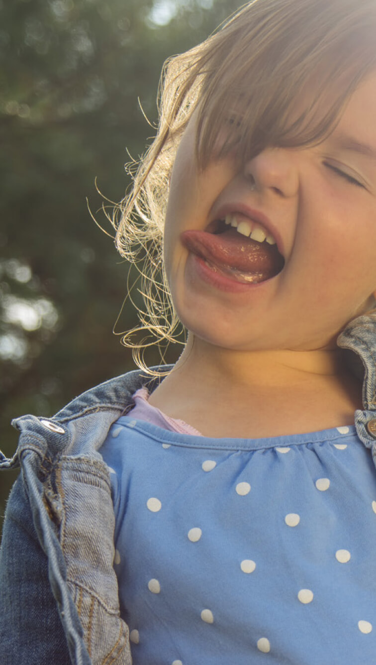 Child smiling with tongue out