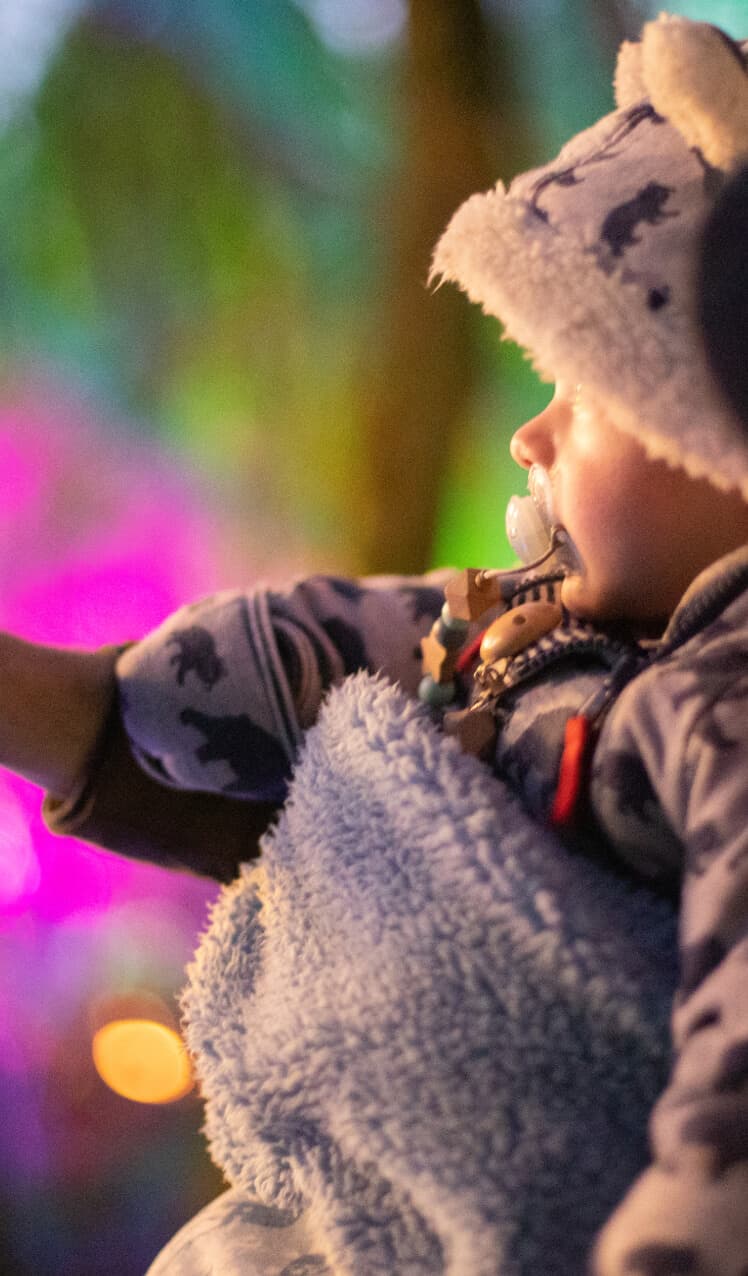 Father and child enjoying colorful lights